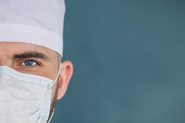 Healthcare, medical concept: Male surgeon's face, close up. Medical officer looks at camera.