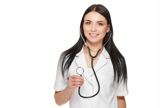 Smiling female doctor showing stethoscope at camera.