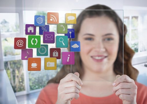 Woman holding glass screen with apps by sunny window