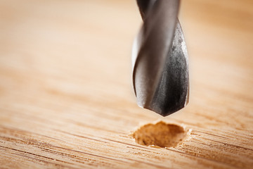 metal drill bit make holes in wooden oaks plank