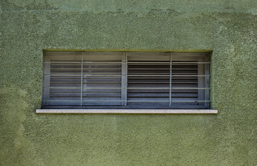 Fragment of green vintage wall with window. Tel Aviv, Israel.