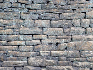 old rough grey stone wall