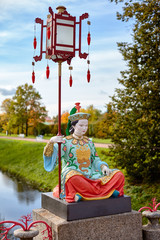 Fototapeta na wymiar Statue on Chinese Grand Bridge 1785, it is reconstructed in 1860 in Alexander Park, Tsarskoye Selo, Pushkin, Saint Petersburg, Russia.