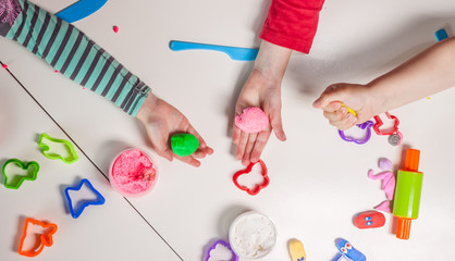 children hands playing with plasticine