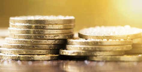 Golden coins closeup - web banner of money savings concept