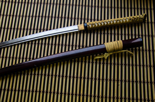 Japanese sword katana and sheath on bamboo mat