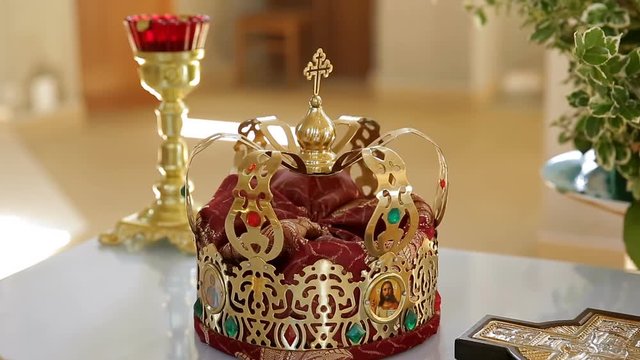 Gold crown on the table. Church wedding. Various accessories for the wedding in the church in Ukraine
