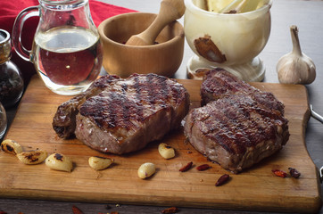 Grill meat rib eye steak composition on wooden background
