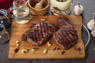 Grill meat rib eye steak composition on wooden background