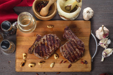 Grill meat rib eye steak composition on wooden background