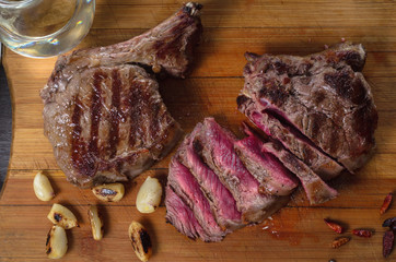 Grill meat rib eye steak composition on wooden background