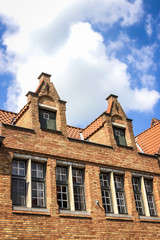 Fototapeta na wymiar Old brick houses and blue sky in Bruges, Belgium