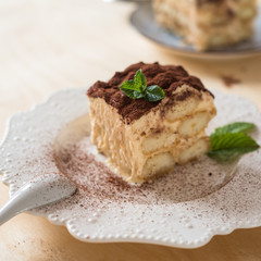 homemade tiramisu cake on wood background