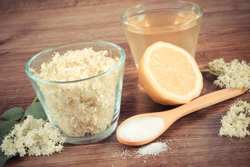 Vintage photo, Flowers and juice of elderberry, ingredients for preparing beverage on board