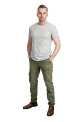 Fototapeta premium Attractive blonde man wearing a grey t-shirt and green pants, standing against a white background with a focused look.