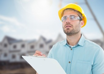 Architect with blueprints on building site