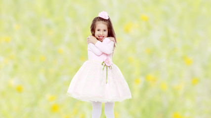 Elegant little girl in a pink dress.