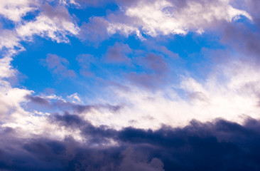 Obraz premium Amazing contrast white and dark clouds and clear blue sky