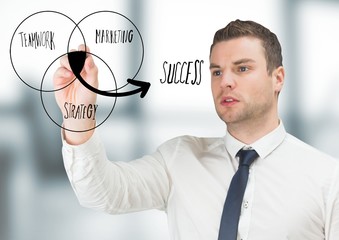 Business man drawing venn diagram doodle in blurry grey office