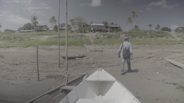 man jumping off boat to village in the riverside
