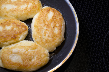 Fried delicious Ukrainian cuisine potato patties in frying pan