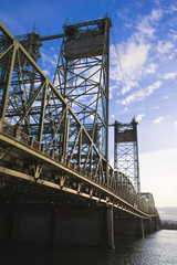 Metal arch truss bridge with liftable sectioned towers