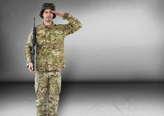 soldier saluting and with weapon. Concrete room