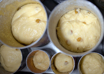 Cylindrical jars with pastry are ready for baking