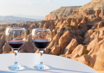 Red Wine glasses on Red valley background in Cappadocia. Turkey