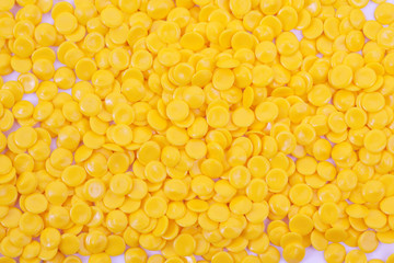 yellow plastic polymer granules background