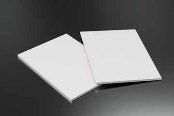 Two blank white closed brochure mock-up on brushed metal background