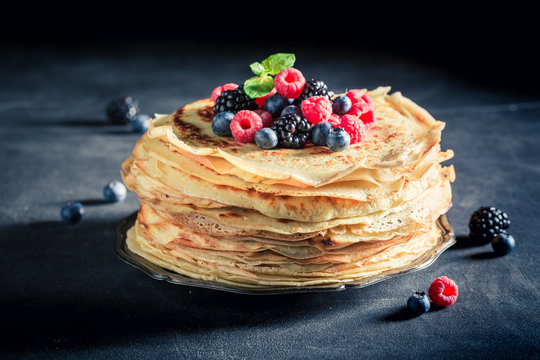 Delicious stack of pancakes with blueberries and raspberries