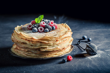 Homemade pancakes cake with fresh berries and mint