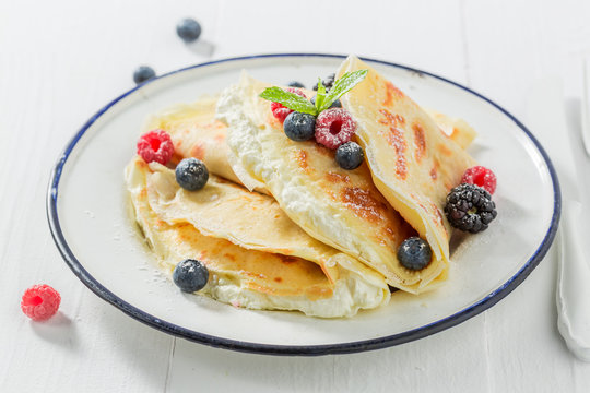 Delicious pancakes with cottage cheese and berries and powder sugar