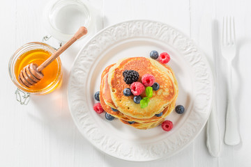 Yummy american pancakes with blueberries and raspberries