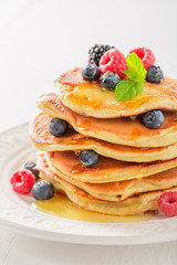 Sweet american pancakes with blueberries and raspberries