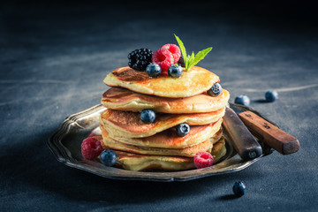 Homemade american pancakes with blueberries and raspberries - obrazy, fototapety, plakaty