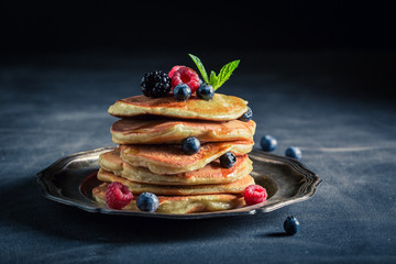 Tasty american pancakes with maple syrup and berries