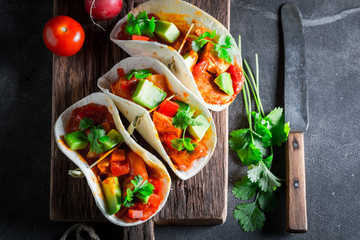 Spicy tacos with avocado, lime and tomato sauce
