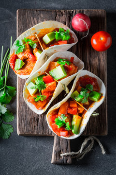 Delicious tacos with spicy sauce and fresh coriander