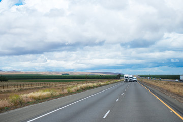 Panorama with road traffic of semi trucks and van