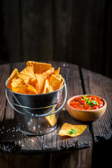 Delicious nachos with red pepper dip and salt