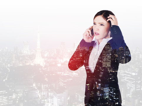 double exposure of worried business woman talking on smartphone with city background