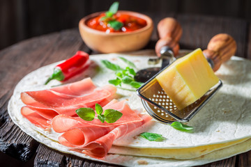 Spicy tortilla as quesadilla with sauce and herbs