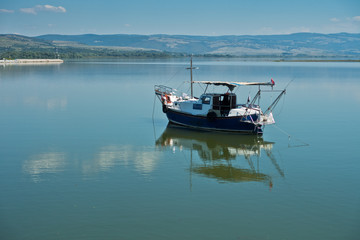 Naklejka na ściany i meble Boat on a calm sunny day at Danube river in Serbia
