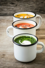 Homemade vegetarian soup made from fresh spinach  pumpkin  tomatoes poured into a white mug