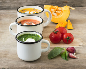 Homemade vegetarian soup made from fresh spinach  pumpkin  tomatoes poured into a white mug