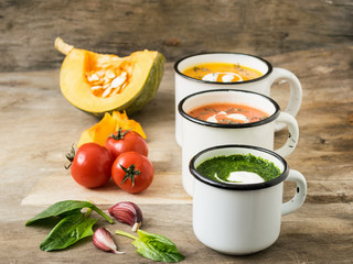 Homemade vegetarian soup made from fresh spinach  pumpkin  tomatoes poured into a white mug