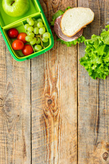 school lunch set with apple and vegetables in lunchbox background top view mock up