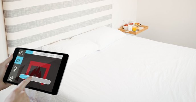 Cropped hands using digital tablet in bedroom